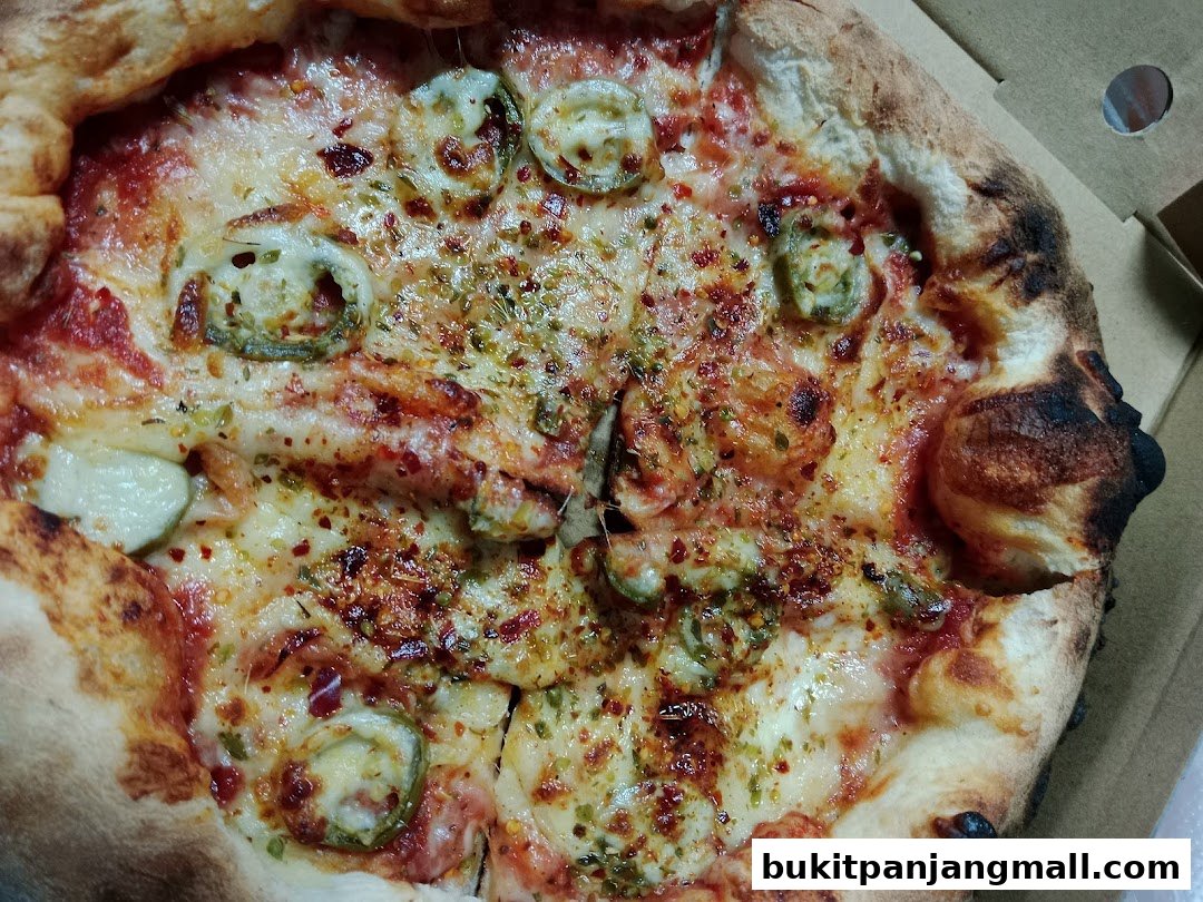 A close-up shot of a delicious pizza with jalapeños and melted cheese.