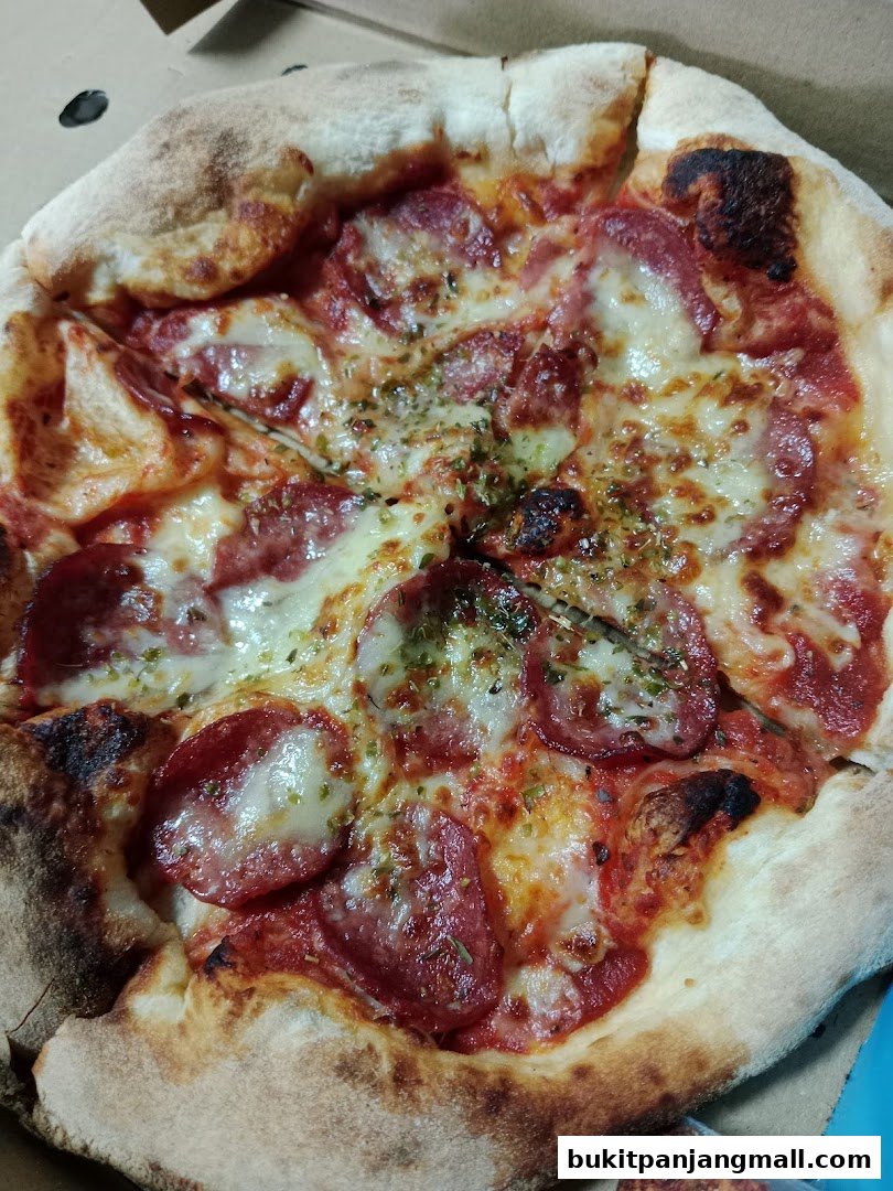 A close-up shot of a delicious pepperoni pizza in a cardboard box.