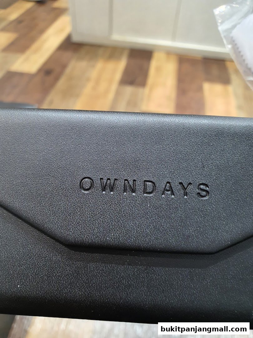 Close-up of a black OWNDAYS glasses case with the brand name embossed.