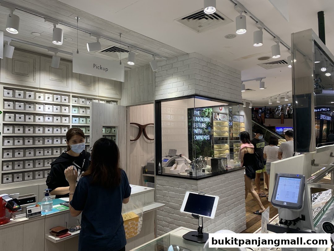 Customers interact with staff at the OWNDAYS optical shop, with shelves of eyewear and equipment visible.