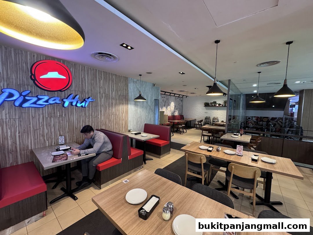 Interior view of a Pizza Hut restaurant with seating and the Pizza Hut logo.