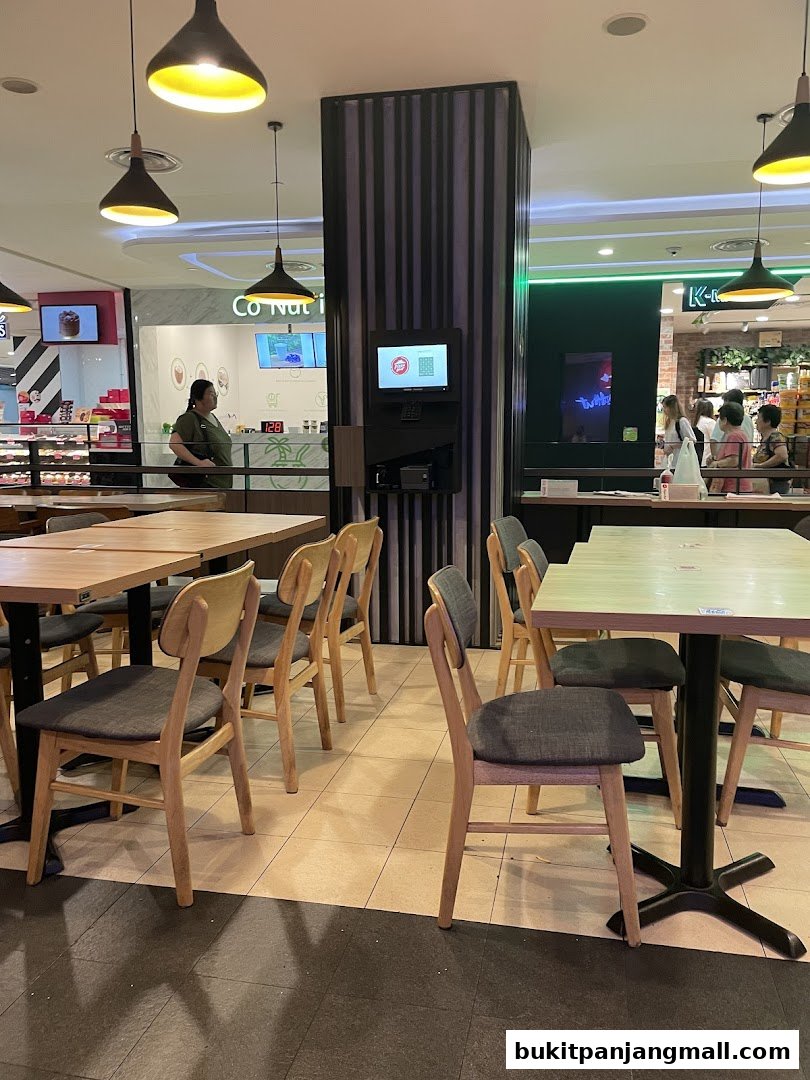 Interior view of a Pizza Hut restaurant with dining tables and chairs.
