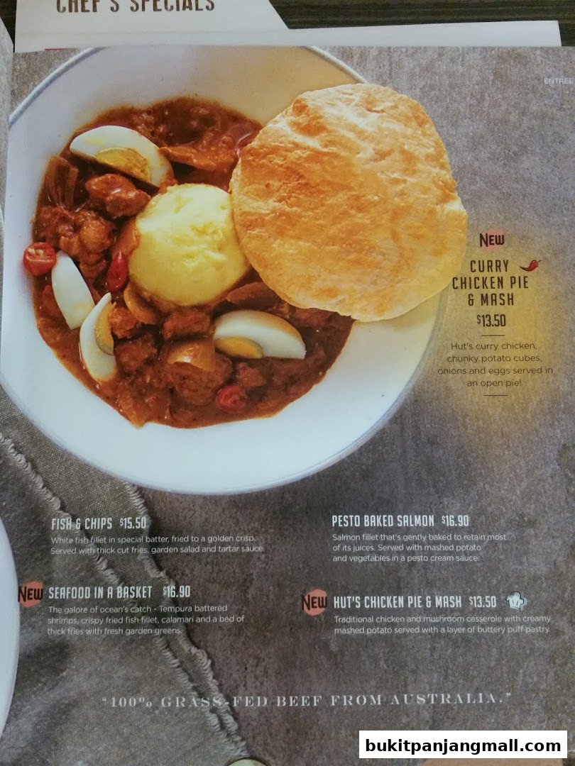 A menu featuring various dishes including curry chicken pie, fish and chips, and salmon.
