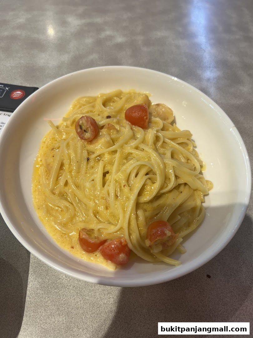 A bowl of creamy pasta with cherry tomatoes and a hint of spice.