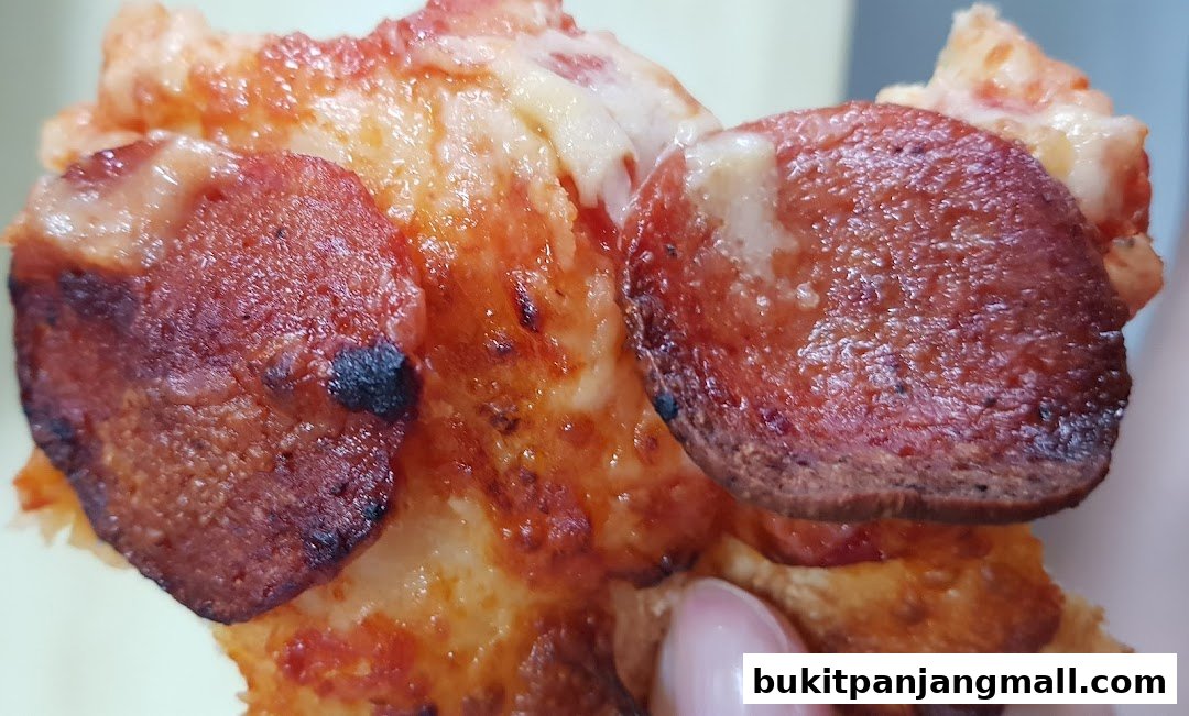 A close-up shot of a slice of pepperoni pizza with melted cheese.