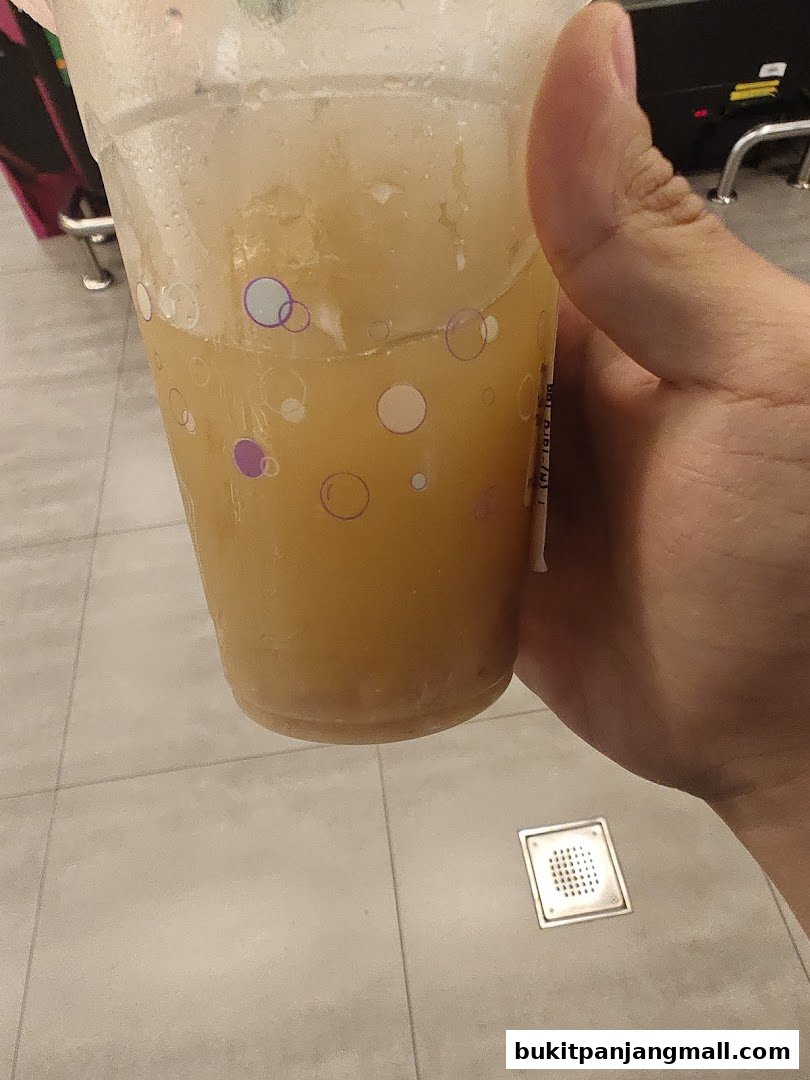 A hand holds a refreshing beverage with ice and bubbles from PlayMade.