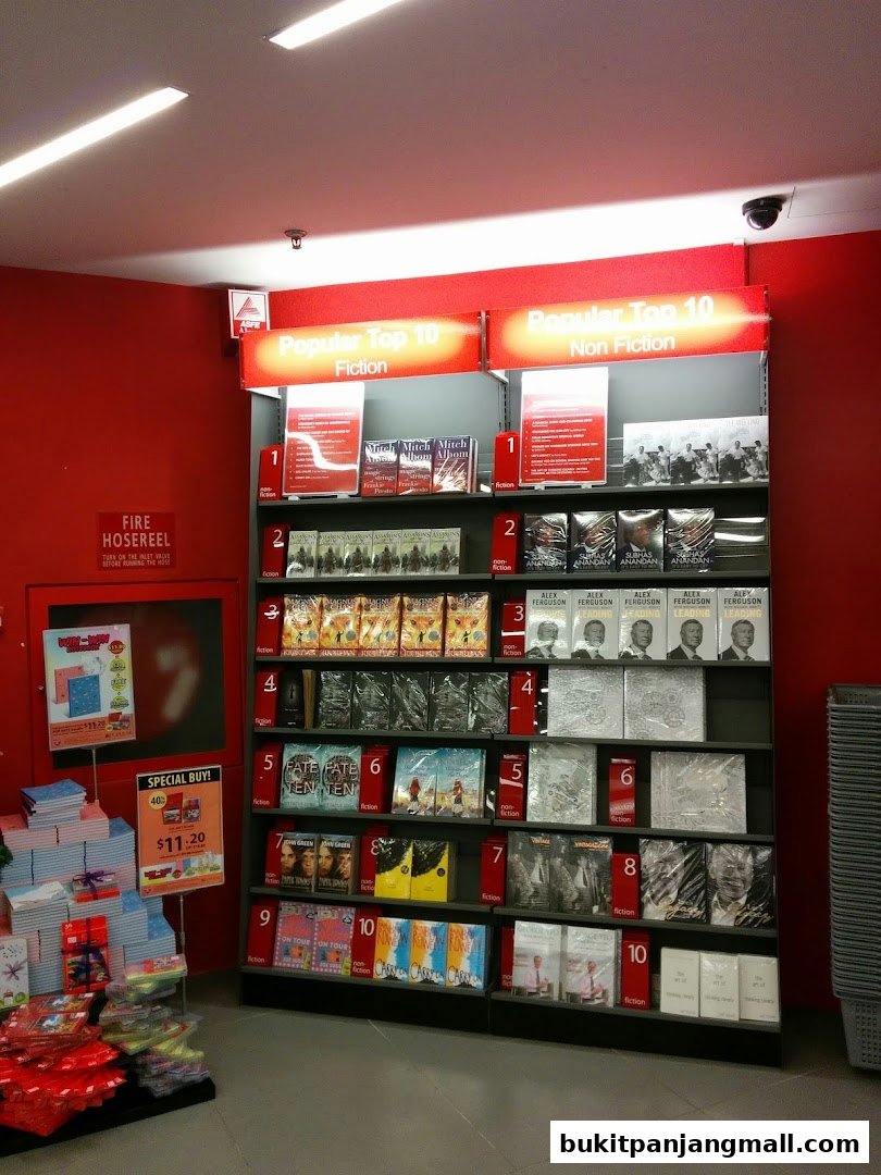 A display of books and merchandise at POPULAR Bookstore, featuring 'Popular Top 10' sections.