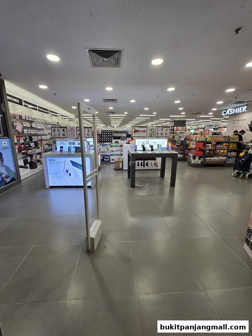 Interior view of a brightly lit retail store with shelves stocked with products and a cashier counter.