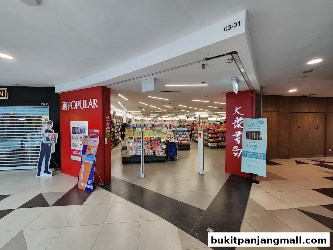 The entrance to a POPULAR bookstore, showcasing books and promotional displays.