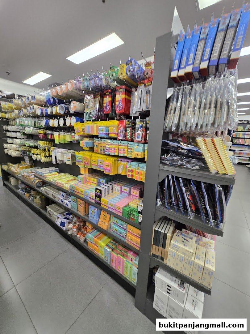 Shelves stocked with a wide variety of stationery, including sticky notes, tape, pens, and binders.
