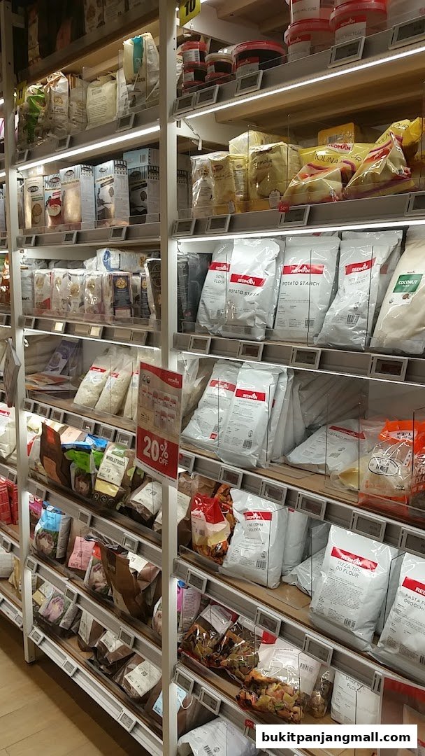 Shelves stocked with various bags of flour and baking ingredients at RedMan.