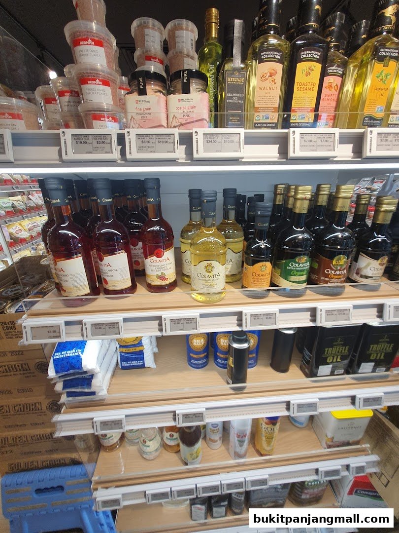 Shelves stocked with various gourmet food items including oils, salts, and sauces.