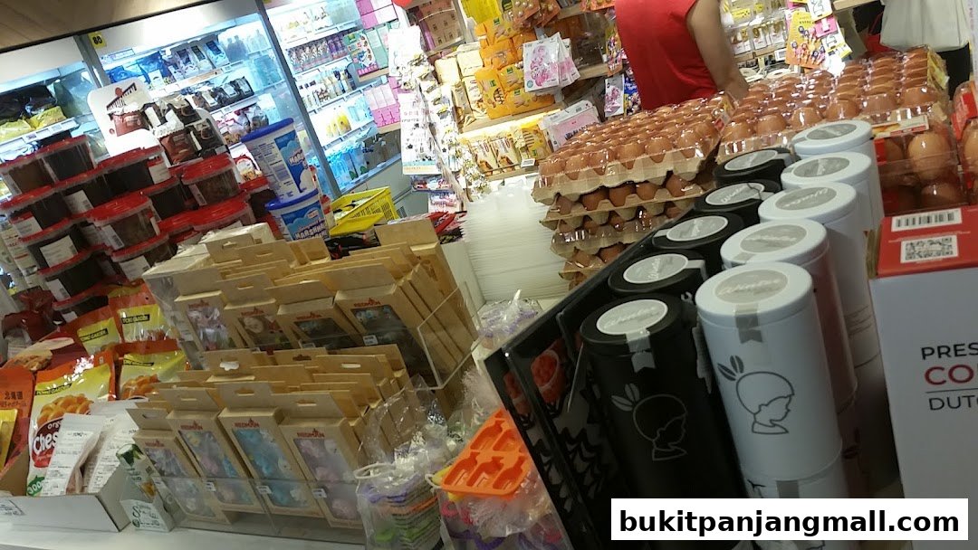 A retail shop interior displaying various food products, including eggs, snacks, and packaged goods.