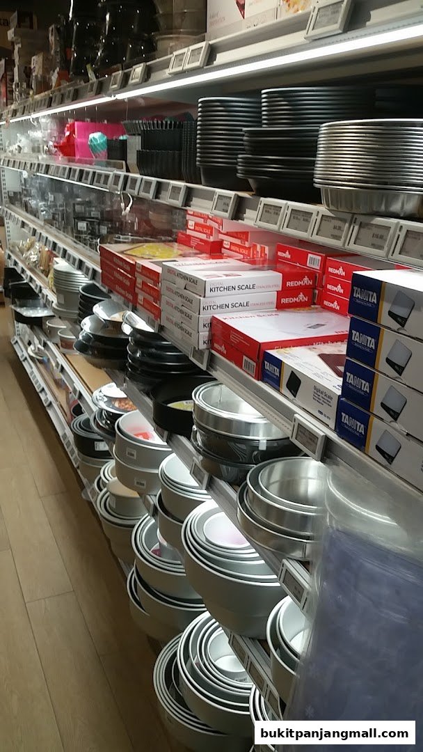 Shelves stocked with baking pans, mixing bowls, and kitchen scales at RedMan.
