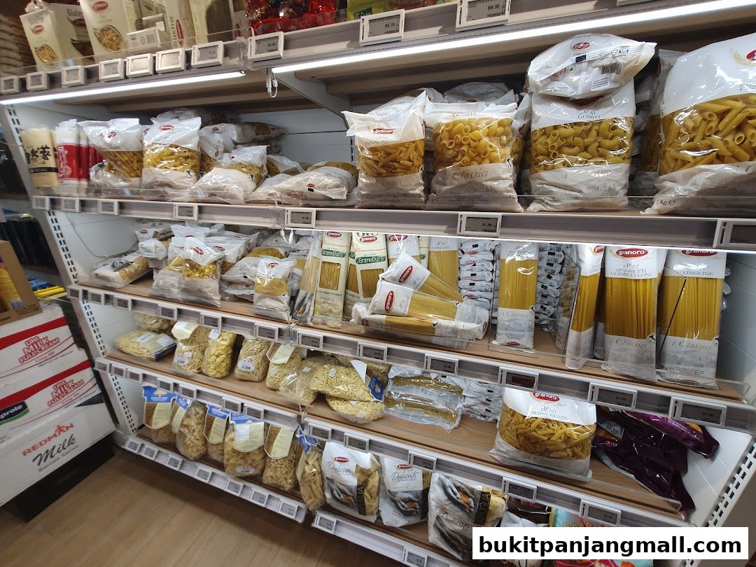 Shelves stocked with various types of pasta and other dry goods in a retail store.