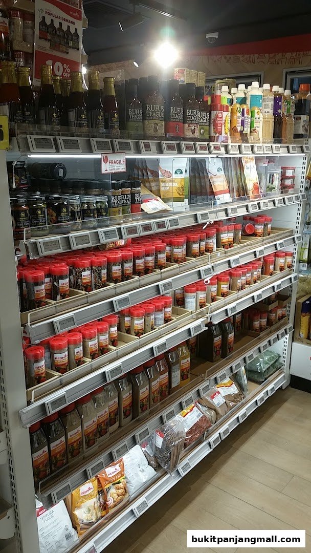 Shelves stocked with various spices, sauces, and baking ingredients at RedMan by Phoon Huat.