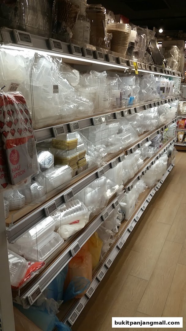 Shelves stocked with various plastic containers, baking supplies, and packaging materials.