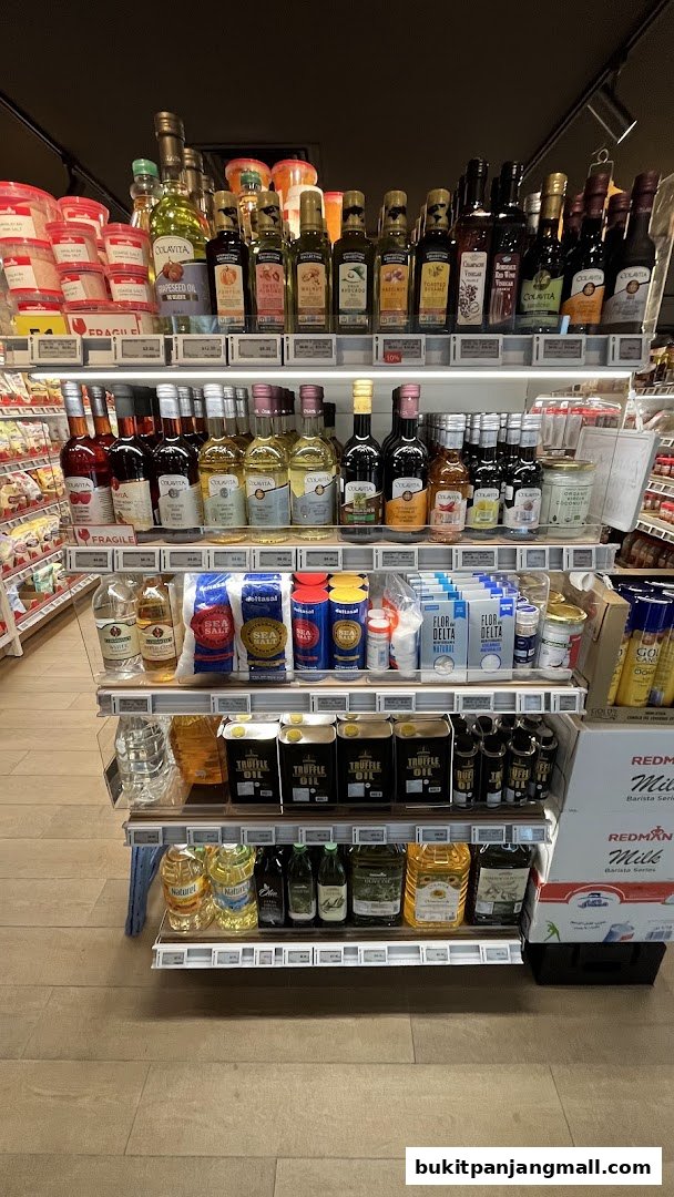 Shelves stocked with various oils, vinegars, salts, and other pantry staples.