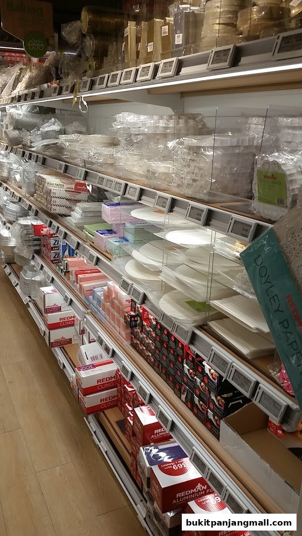 Shelves stocked with baking supplies like wax paper, cling film, and doilies.