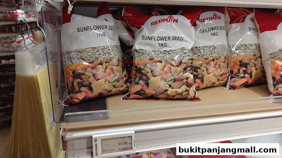 Bags of sunflower seeds and mixed nuts/dried fruits are displayed on a shelf.