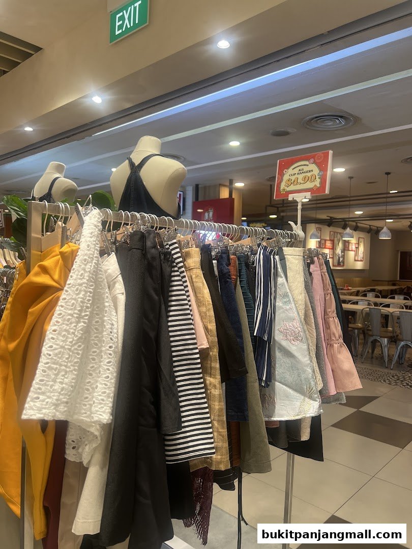 A rack of assorted women's clothing displayed with mannequins and a sale sign.