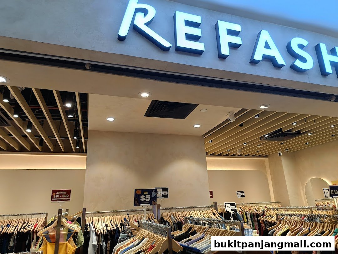 The REFASH store entrance with racks of clothing and promotional signs.