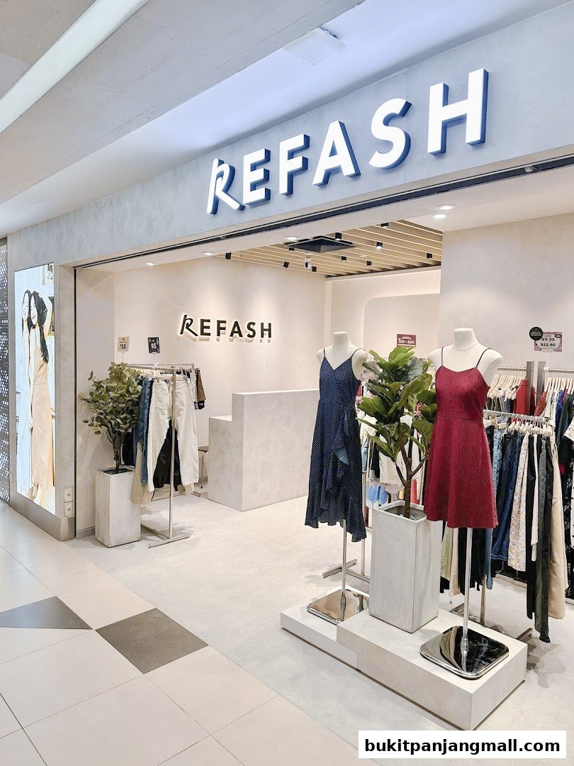The Refash store entrance displays clothing on mannequins and racks, with plants and a counter inside.