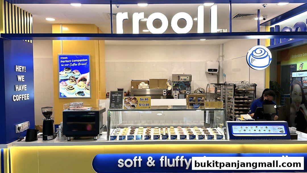 A brightly lit bakery counter displaying a variety of cinnamon rolls and a coffee menu.