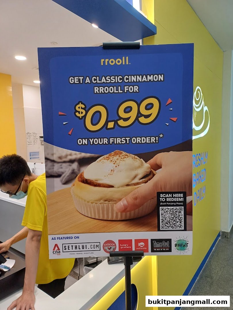 A sign advertises a classic cinnamon rrooll for $0.99 on the first order.