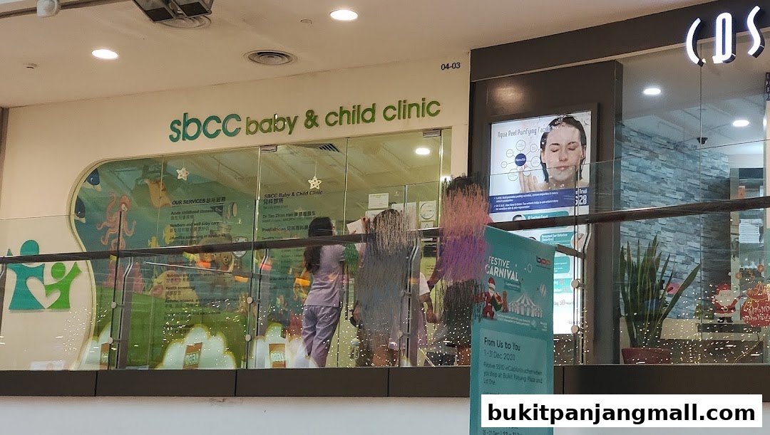 The entrance of SBCC Baby & Child Clinic with colorful decorations and a promotional poster.