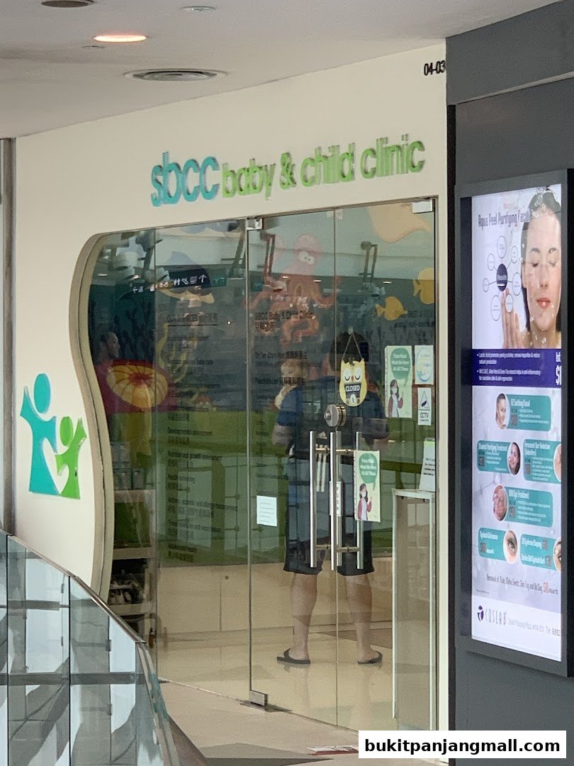 The entrance to SBCC Baby & Child Clinic, featuring glass doors and a prominent sign.