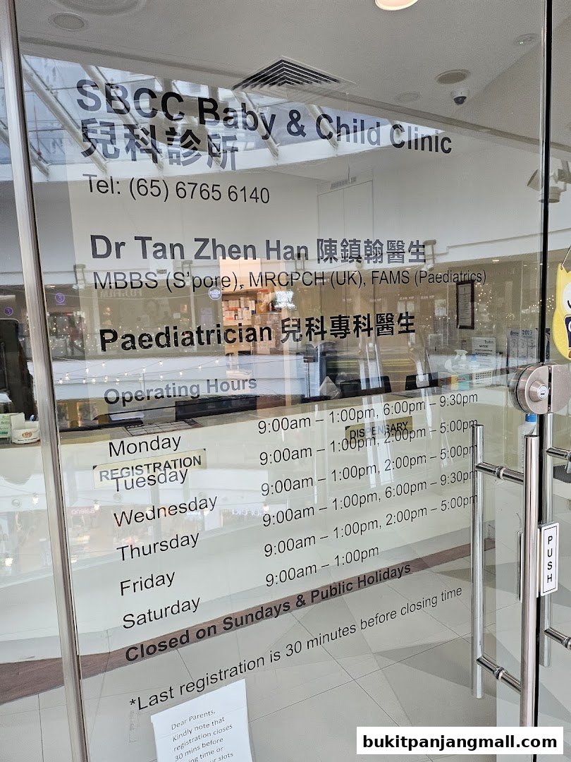 Glass door of a baby and child clinic with operating hours and doctor's information.