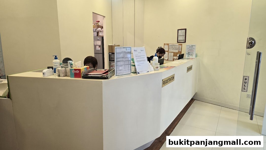 The reception area of a baby and child clinic with staff at the counter.