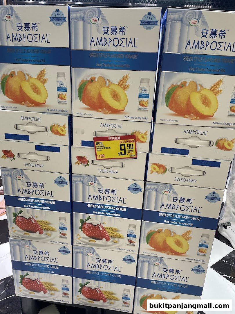 Stacks of Ambrosial Greek Style Flavoured Yoghurt in peach and strawberry flavors.