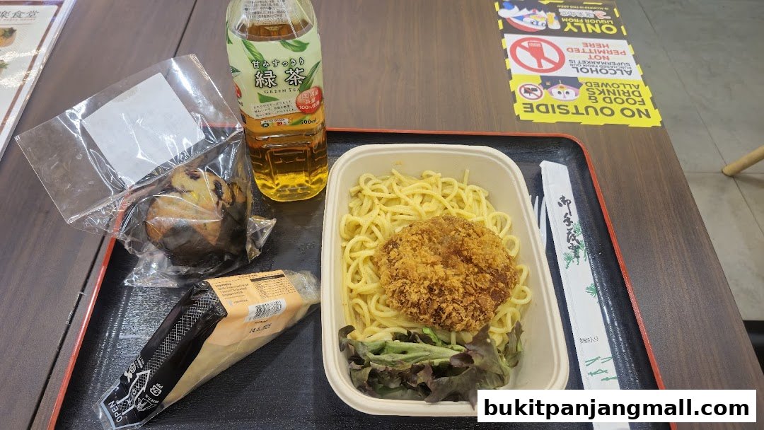 A tray with pasta, a fried cutlet, green tea, and a pastry.