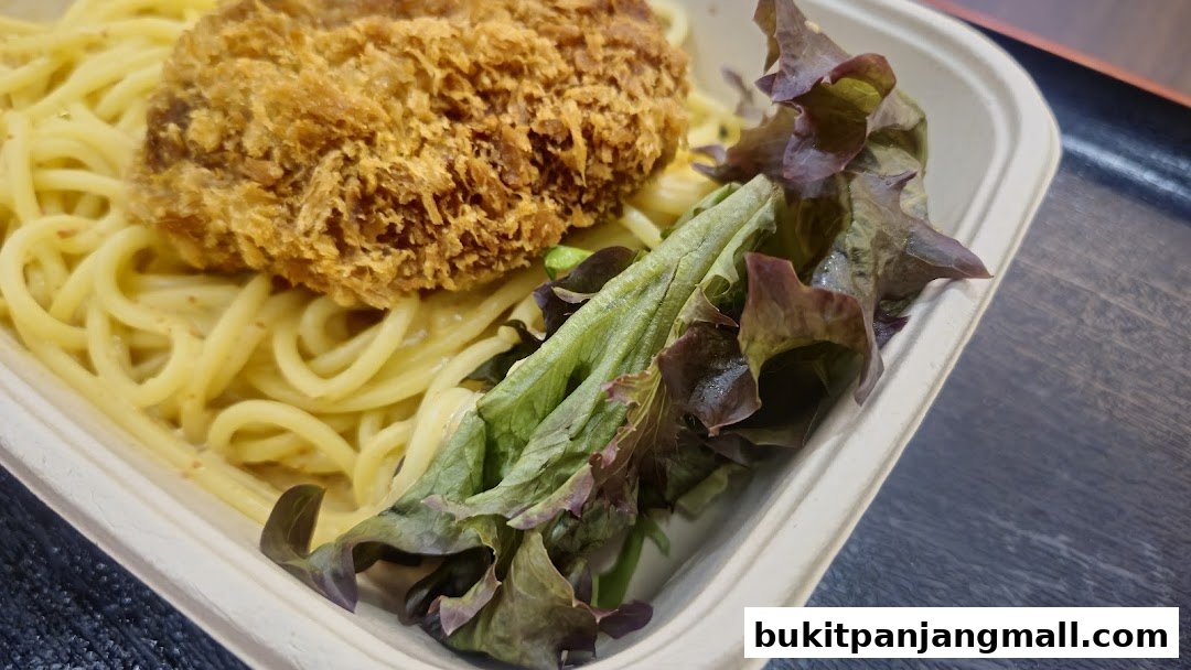 A close-up of a pasta dish with a crispy cutlet and fresh salad in a takeaway container.