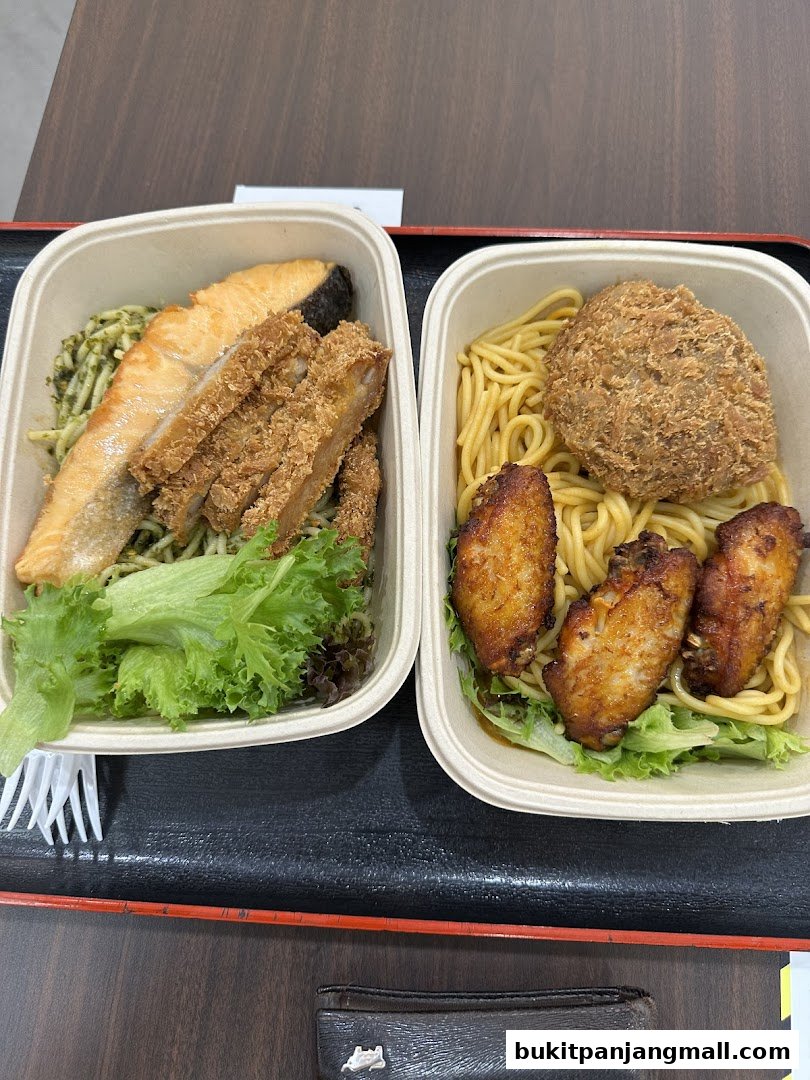 Two takeaway containers filled with pasta, fried chicken, salmon, and chicken wings.