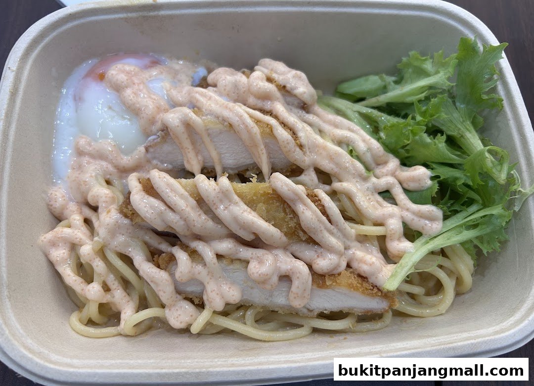 A close-up of a pasta dish with fried chicken, a poached egg, and creamy sauce.