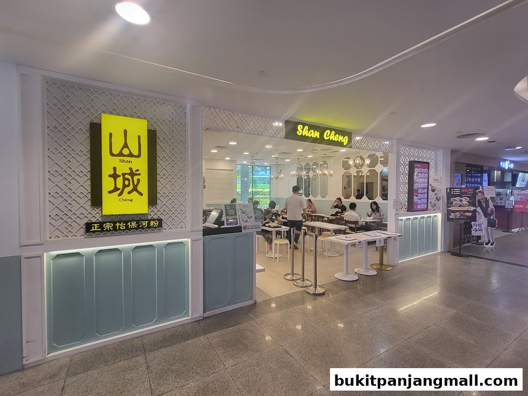 The exterior of Shan Cheng Ipoh Delicacies restaurant with customers dining inside.