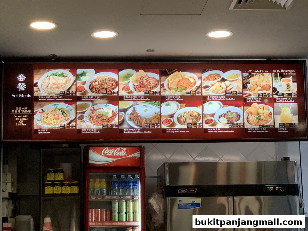 A menu board displaying various Ipoh delicacies, including set meals, side orders, and beverages.