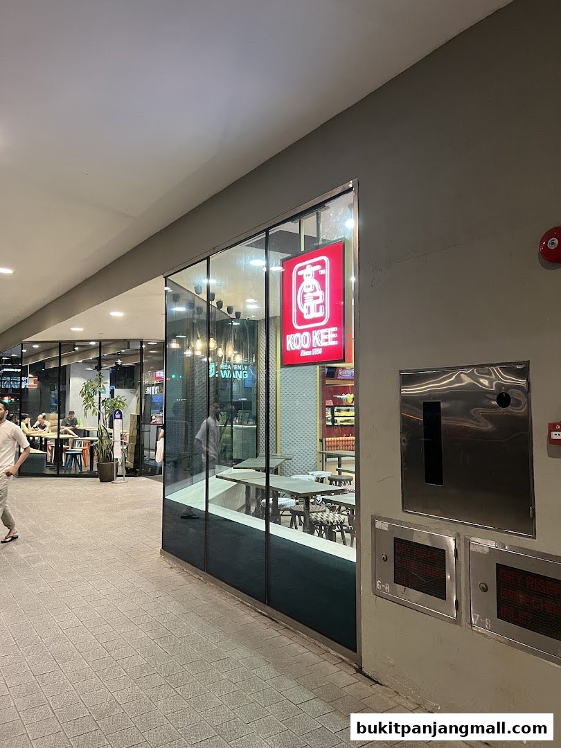 The exterior of a brightly lit restaurant with a prominent red sign.