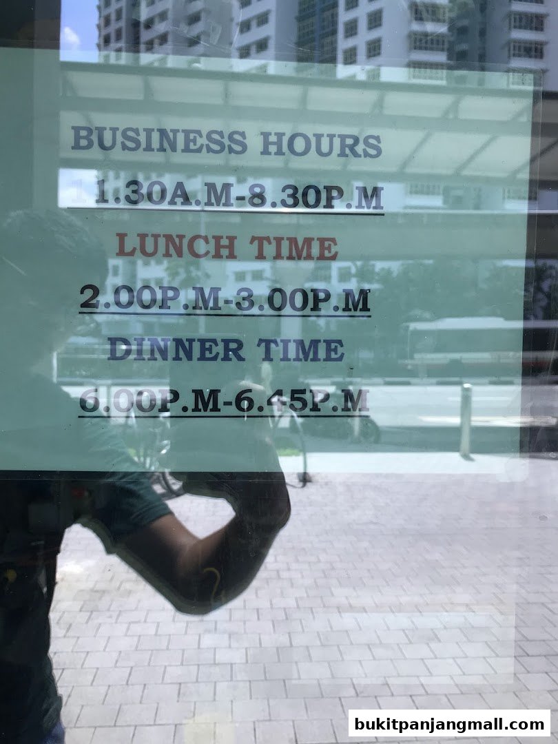 A sign displaying business hours for a shop, including lunch and dinner times.