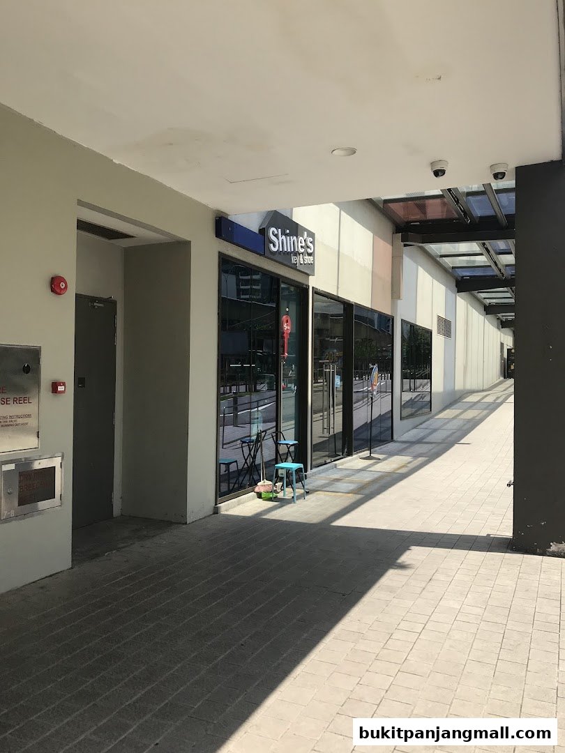 The exterior of Shine's Key and Shoe shop with its signage visible.