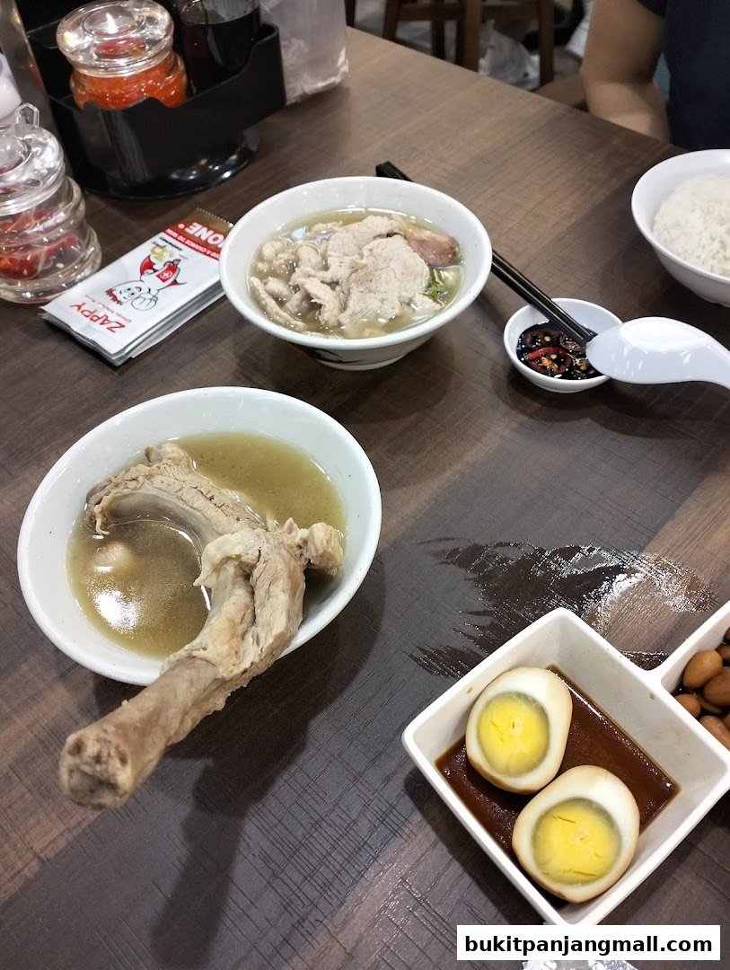 A table laden with delicious Song Fa Bak Kut Teh dishes, including pork ribs and braised eggs.