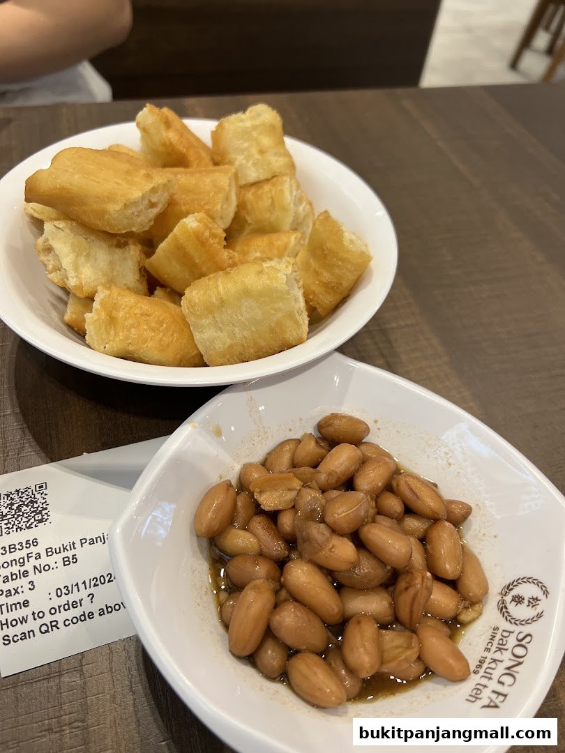 Bowls of fried dough fritters and braised peanuts served at Song Fa Bak Kut Teh.