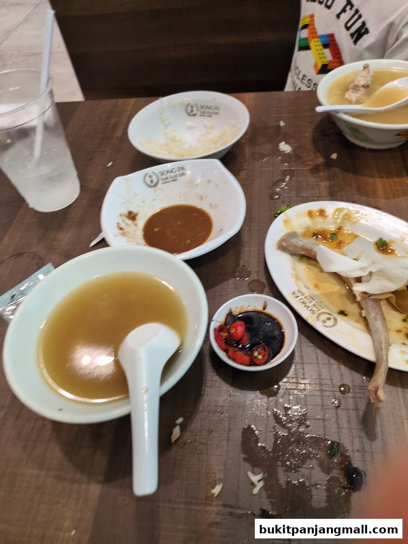 A table at Song Fa Bak Kut Teh with leftover food and drinks.