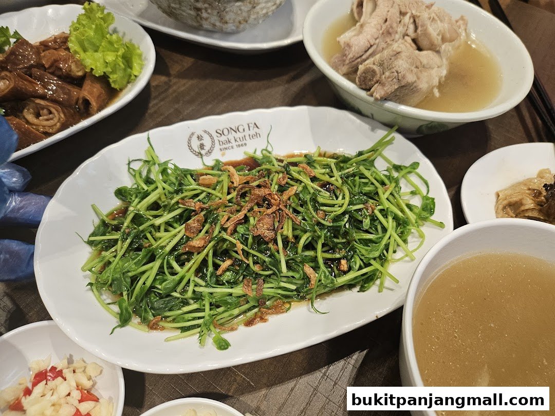 A spread of delicious dishes from Song Fa Bak Kut Teh, featuring tender pork ribs and fresh vegetables.