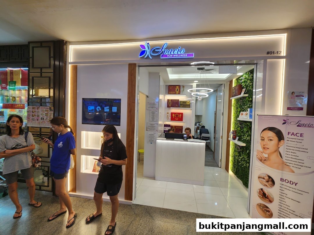 The entrance of Spacio TCM Wellness, a beauty and wellness center, with a promotional poster.
