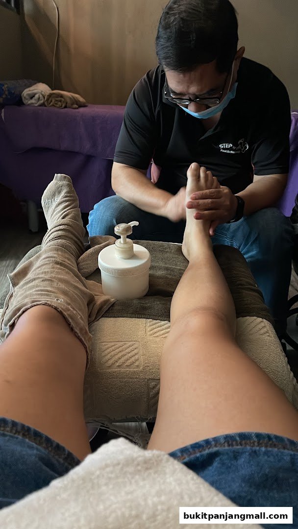 A person receives a foot massage from a therapist at Step by Step.
