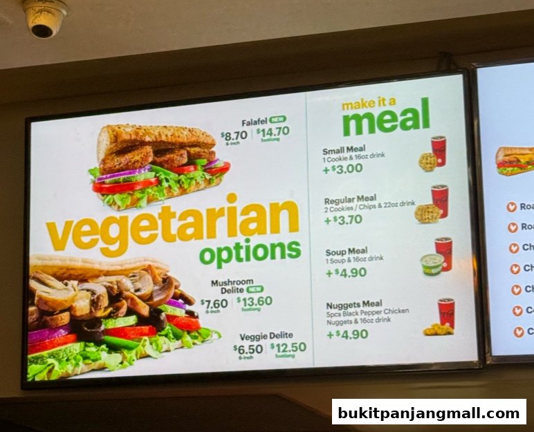 A digital menu board displaying vegetarian sandwich options and meal deals at Subway.